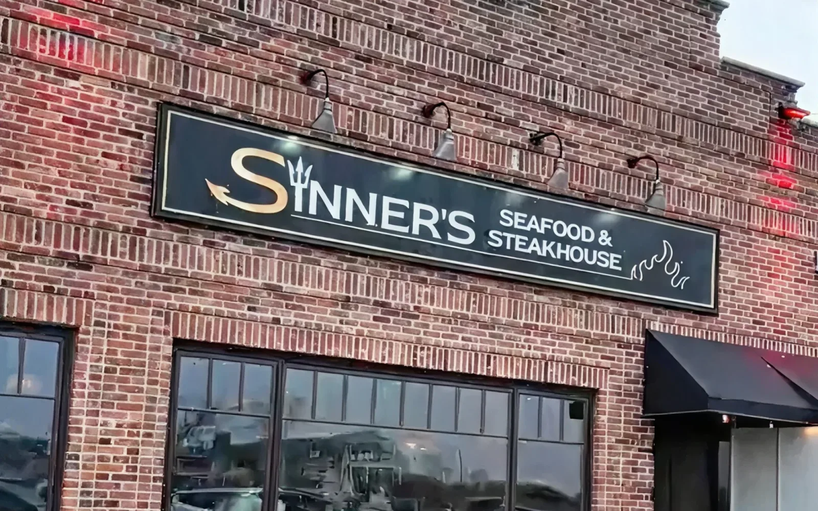 Sinner's Seafood & Steakhouse sign on the brick front of the Point Pleasant Beach, NJ restaurant